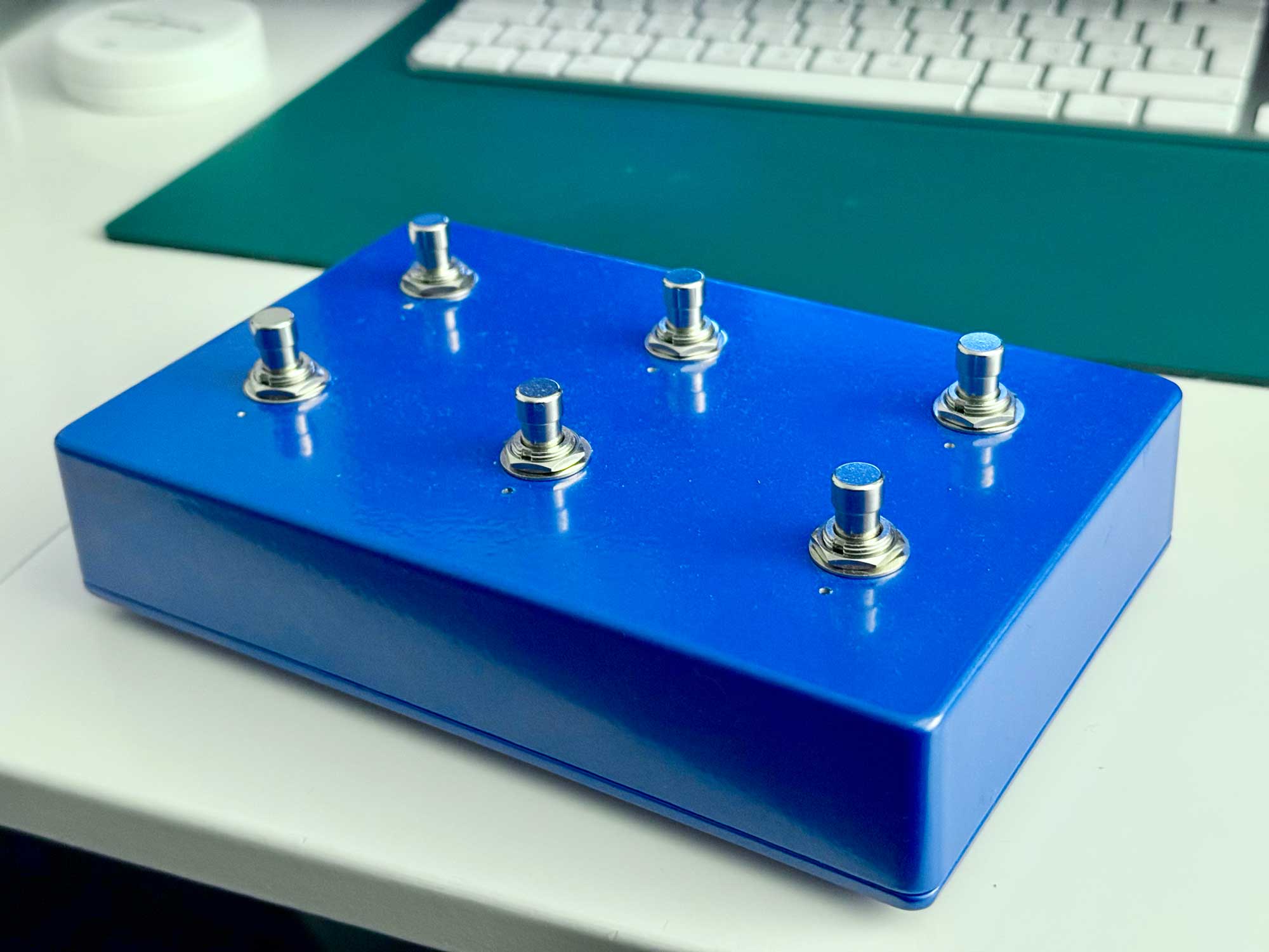The finished MIDI footswitch controller, blue diecast aluminum enclosure with six chrome switches